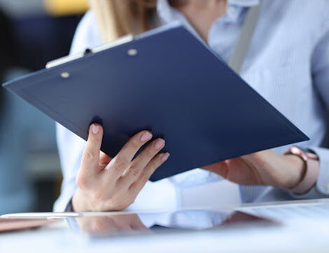 An assessor holding a clipboard