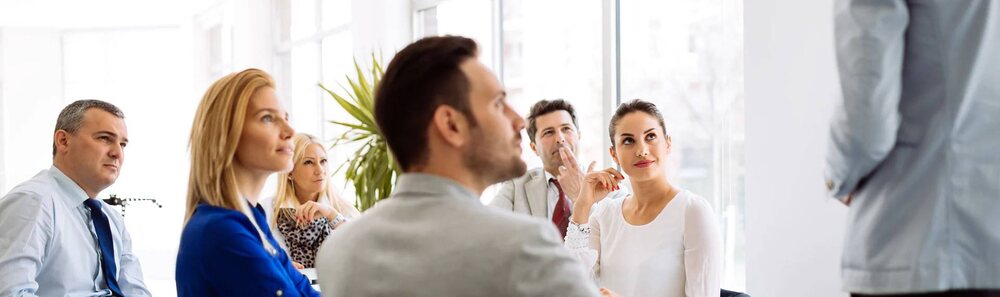 An adviser talking through options with two clients