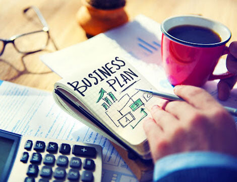 A business plan being drafted at a desk