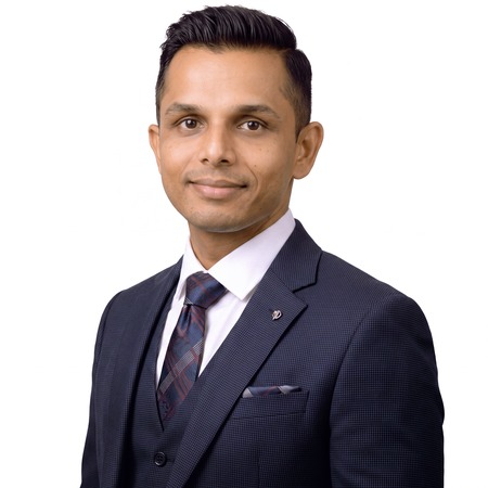 Vijay Patel | Career Calling International A man in a suit and tie poses for a professional headshot of Vijay Patel.